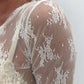 Top trasparente a maniche lunghe con ricamo floreale